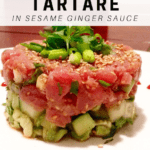 tuna tartare on plate with pink sauce surrounding it