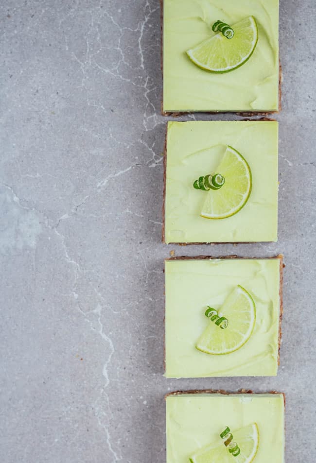 4 key lime pie bars on a grey board