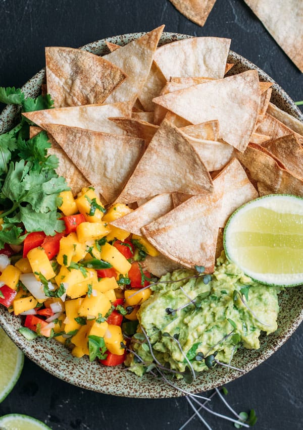 Baked corn chips with guacamole and mango salsa
