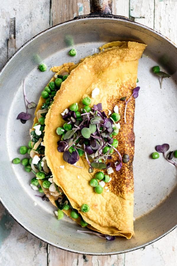 Chickpea omelette with spinach and spring peas