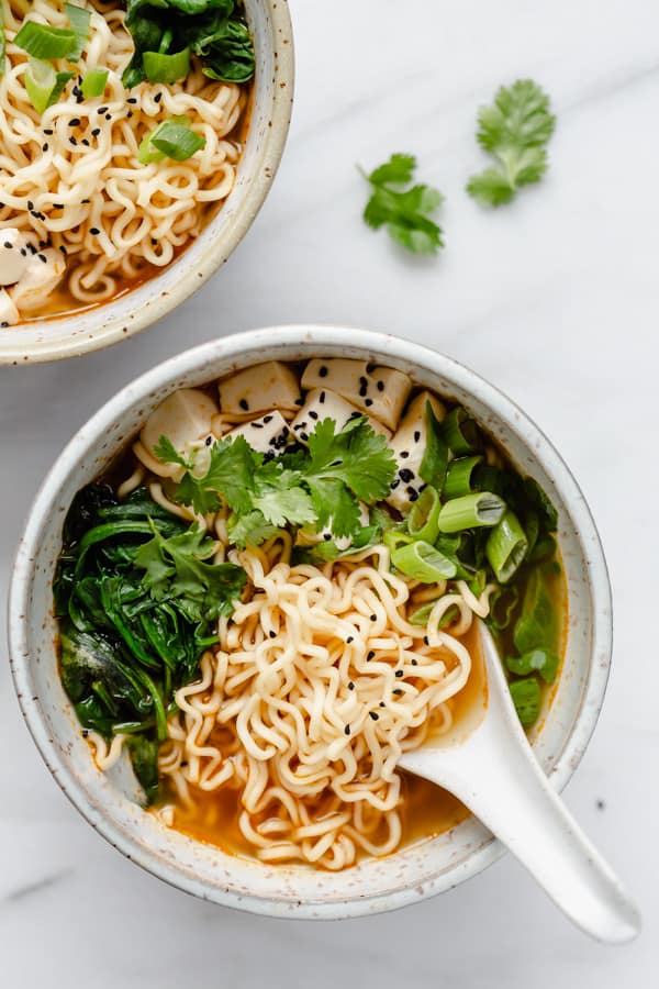 vegan ramen in broth with spoon and bowl