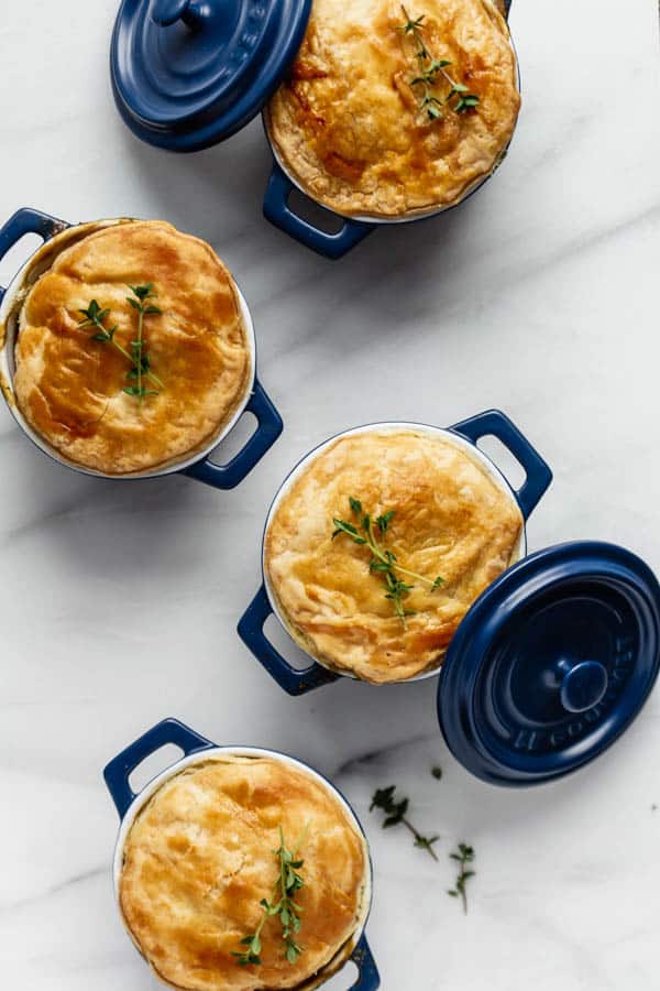 four vegetable pot pies in small ramekins with a puff pastry crust