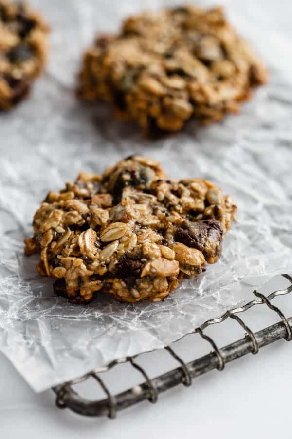 Focused photo of a healthy breakfast cookie on a cooling tray with blurring cookies behind.