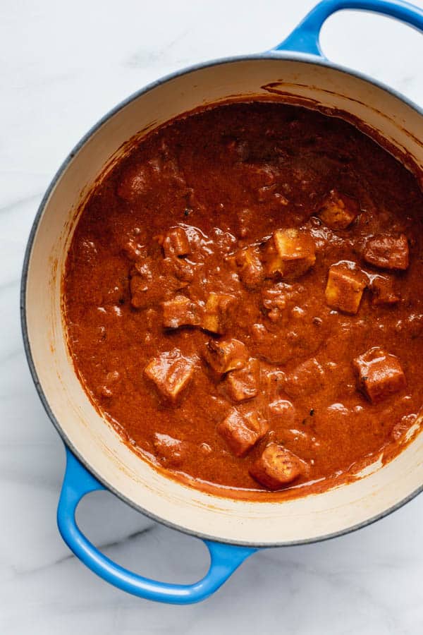 a blue french oven filled with tofu tikka masala 