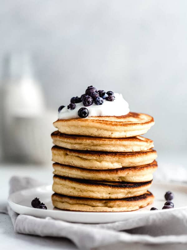almond flour pancakes on a white plate topped with blueberries