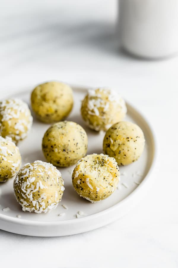  bliss balls on a white plate on a white table