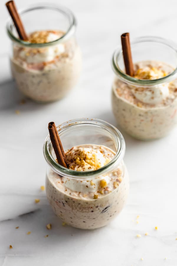 3 jars of carrot cake overnight oats on a marble board