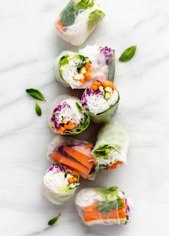 cut up rice paper rolls on a marble board