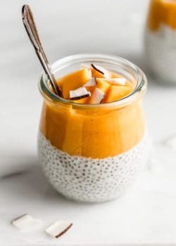 a jar with coconut chia pudding topped with mango puree