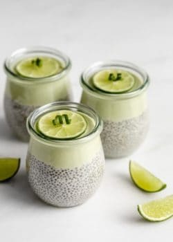 3 jars of key lime chia pudding with lime wedges on the side