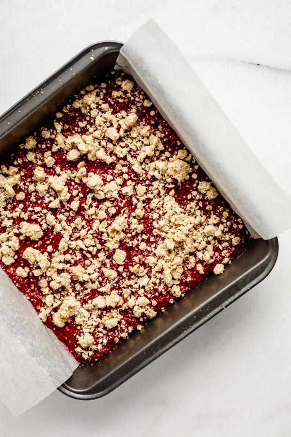 raspberry crumble bars in a pan uncooked
