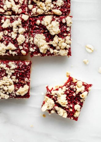 raspberry crumble bar with a bite taken out of it