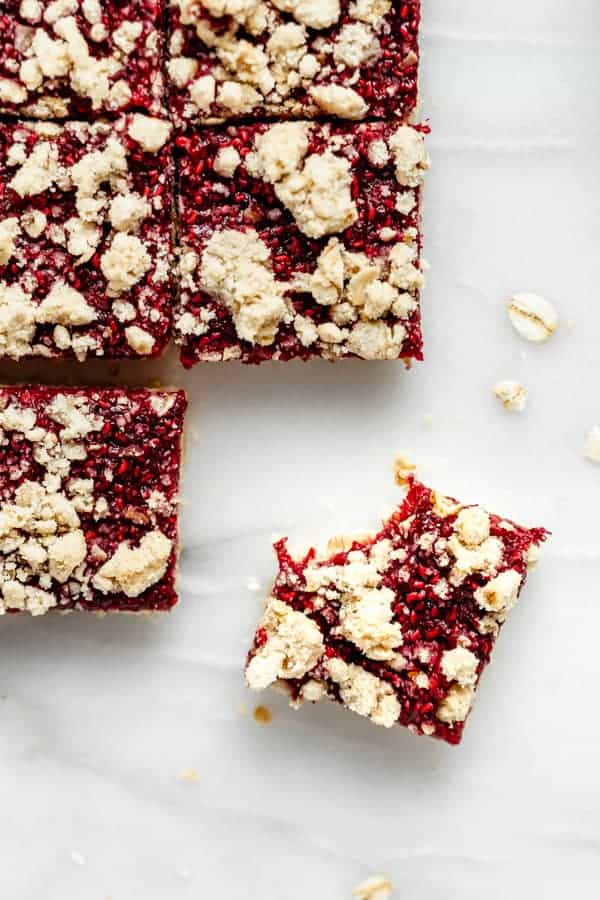 raspberry crumble bar with a bite taken out of it