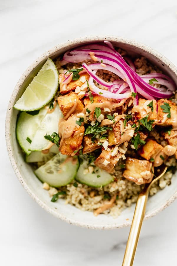 tofu, cucumber, pickled onions and quinoa in a bowl