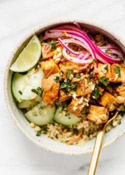 a bowl with tofu pickled onions and cucumber on quinoa