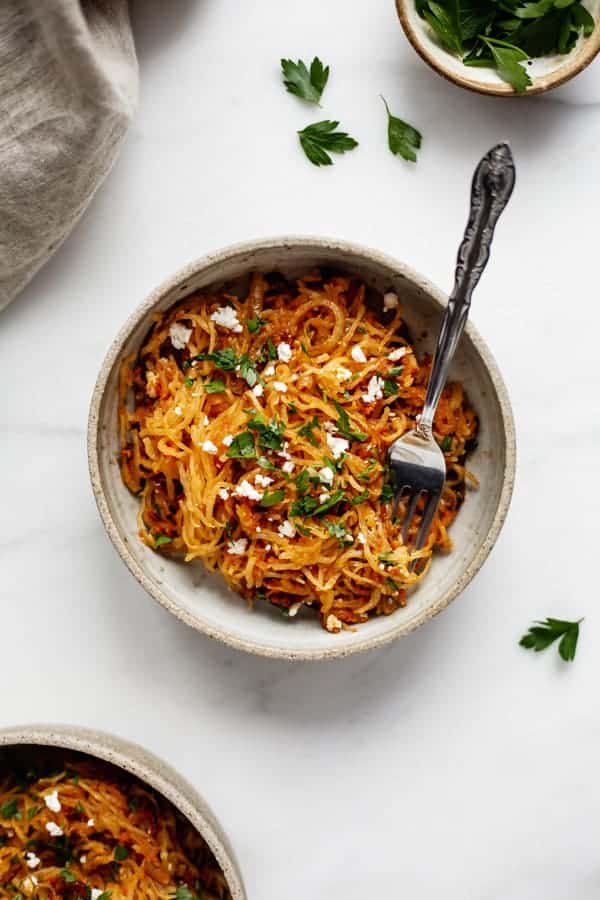 a cermaic bowl with sun dried tomato spaghetti squash