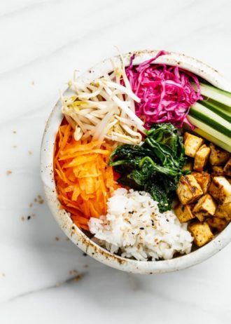 a bowl with carrots, rice, tofu and vegetables