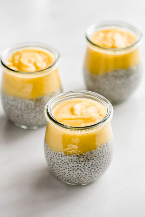 3 jars with chia pudding and pineapple puree on top