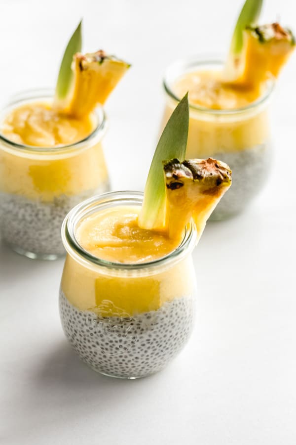 3 jars of pina colada chia pudding with a slice of pineapple on top