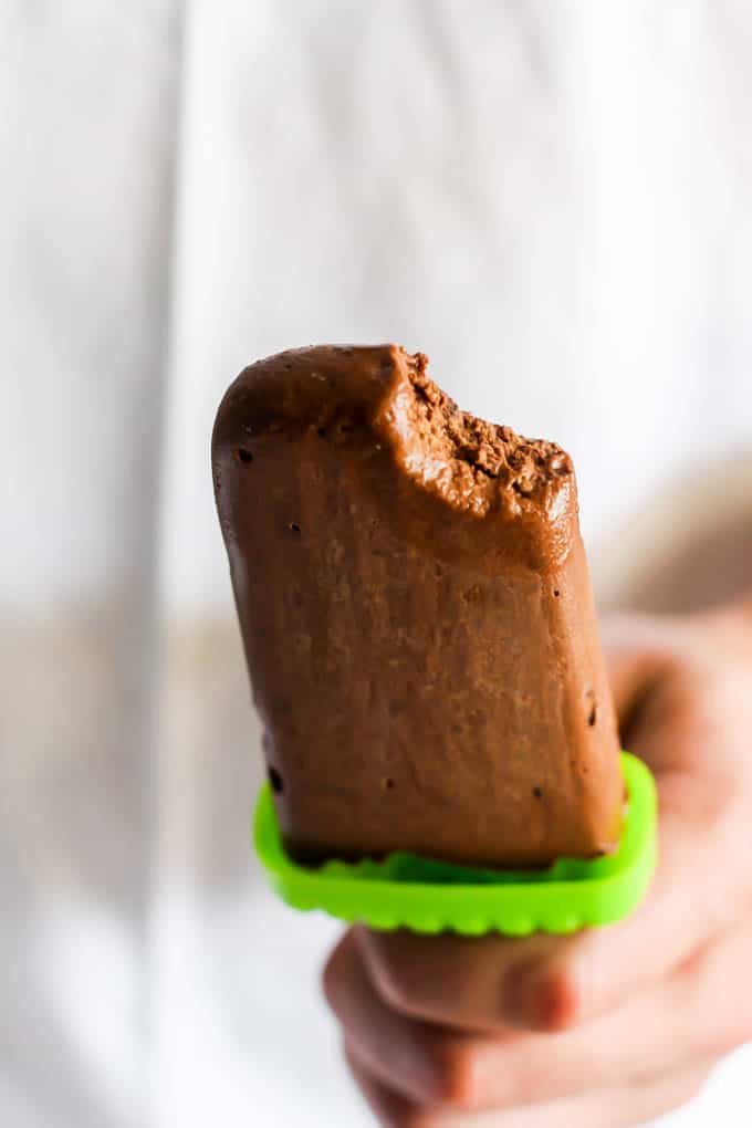 an avocado fudge pop with a bite taken out of it