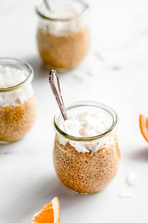 chia pudding in a small jar topped with shredded coconut