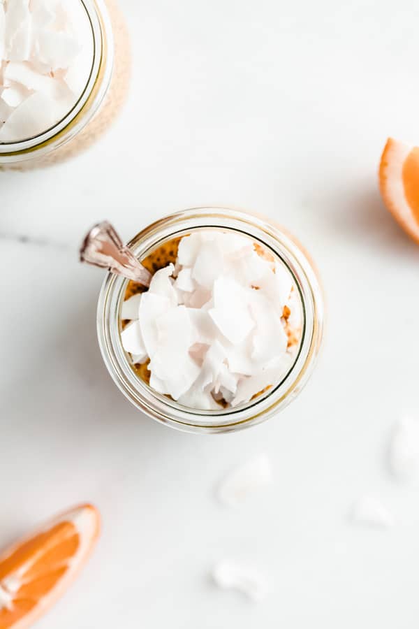 a top down view of a cup of chia pudding with shredded coconut