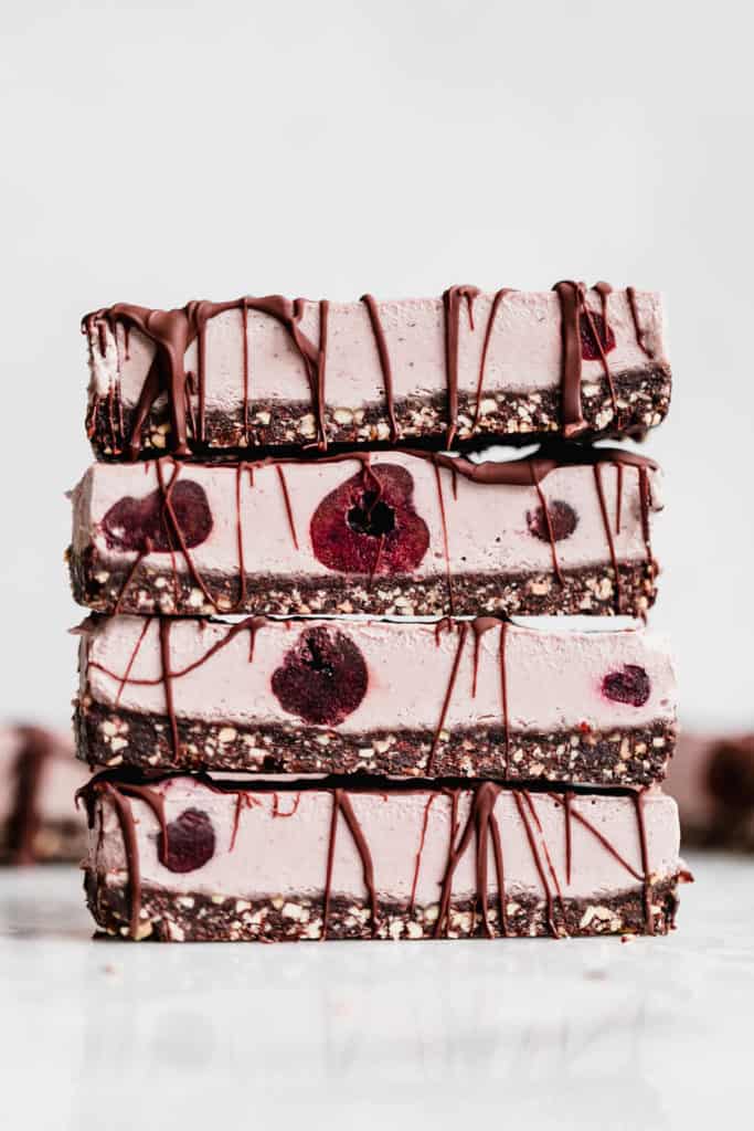 a stack of 4 vegan cherry cheesecake bars 