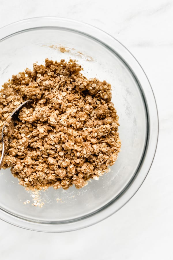 a mixing bowl with crumble mixture in it