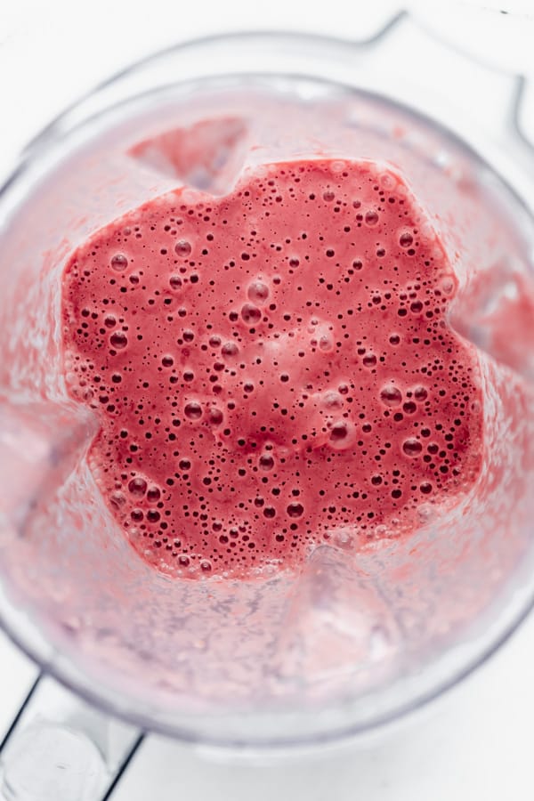 blended raspberries and cashew milk in a blender