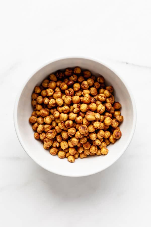 a white bowl with roasted chickpeas in it