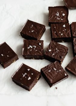no bake brownies cut up in squares on parchment paper