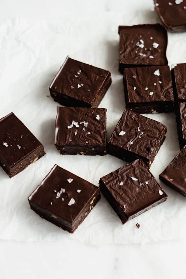 no bake brownies cut up in squares on parchment paper