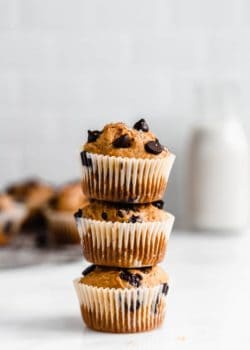 three pumpkin chocolate chip muffins stacked on top of each other