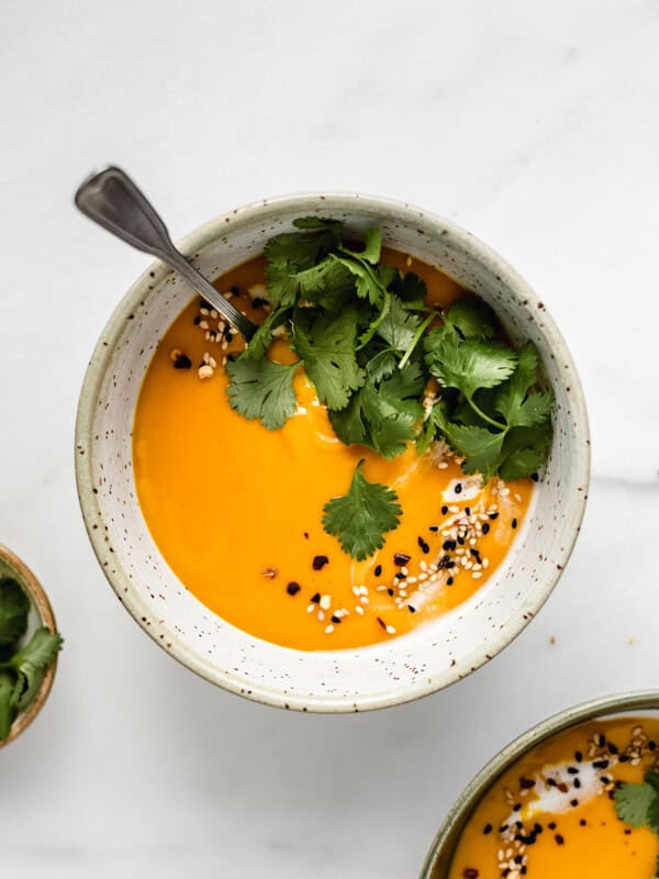 A bowl of butternut squash soup topped with cilantro