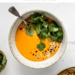 a bowl of butternut squash soup topped with cilantro