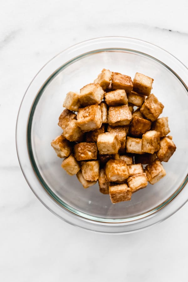 cooked cubes of tofu in a clear bowl
