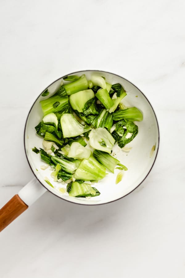 Bok choy chopped up in a white pot