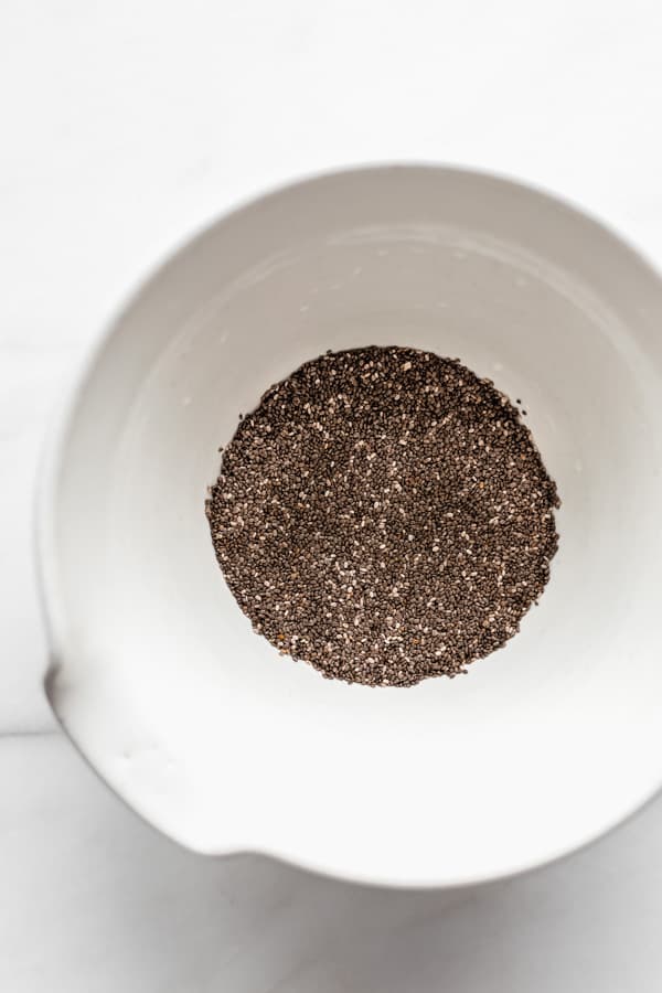 a white mixing bowl with chia seeds in it