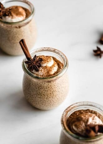 a cup of chai latte chia pudding topped with yogurt, cinnamon and star anis