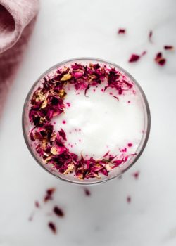 a hibiscus rose latte topped with rose petals