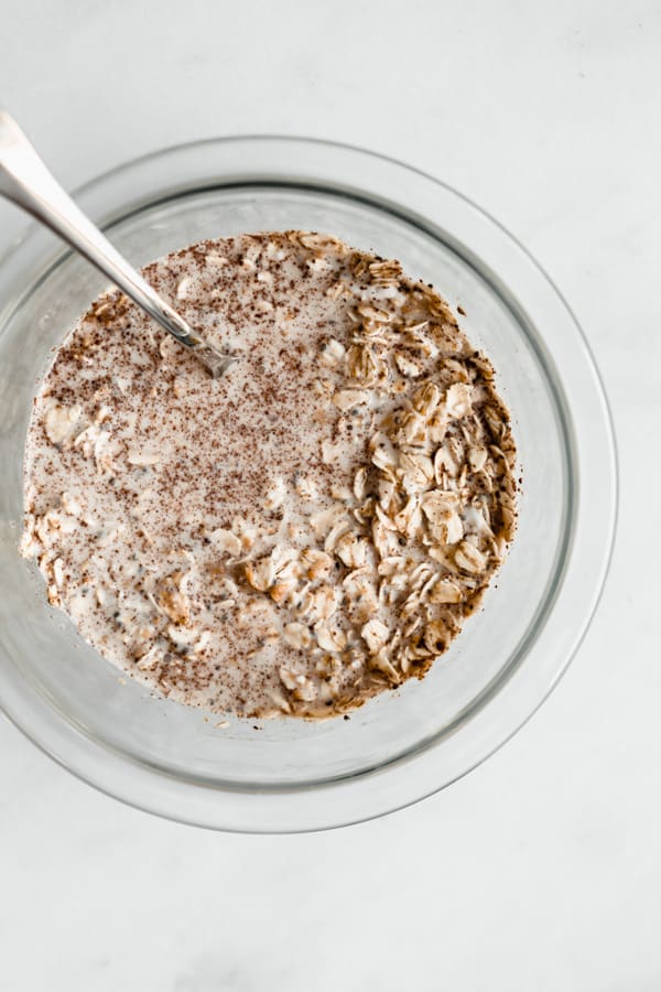 a mixing bowl of ingredients for peanut butter overnight oats