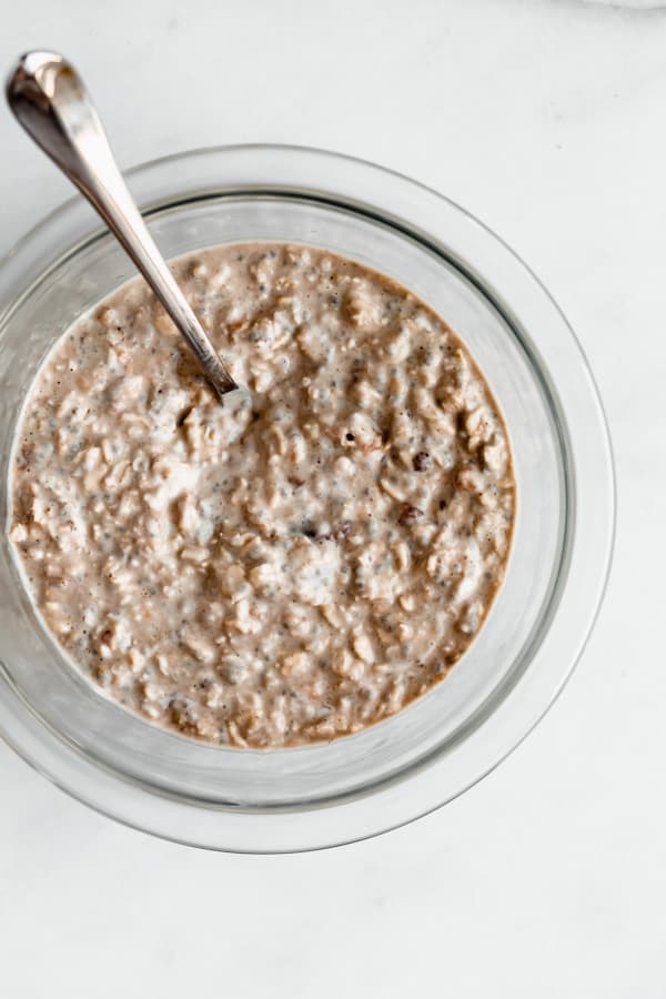 a clear mixing bowl of peanut butter overnight oats