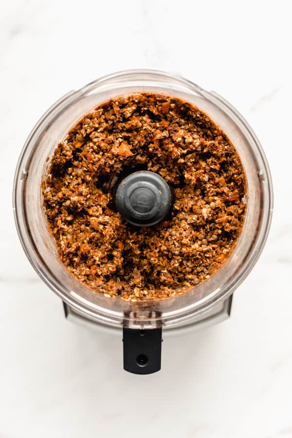 a food processor with lentil loaf mixture in it