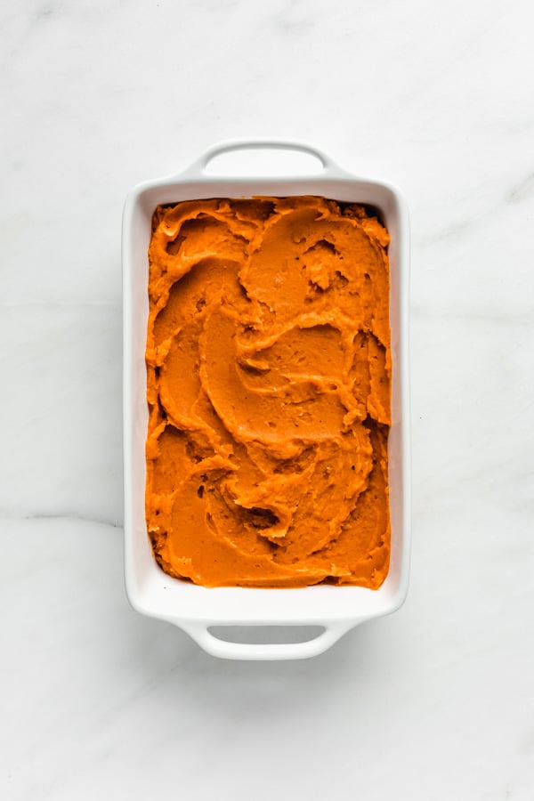 a baking dish with mashed sweet potato in it