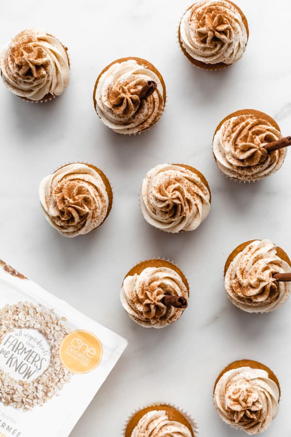 a top down view of pumpkin cupcakes on a marble board