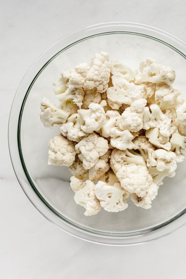 cauliflower florets in a clear mixing bowl