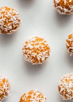 an apricot energy ball with shredded coconut