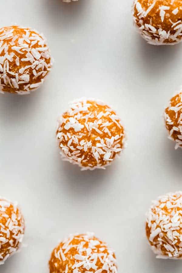 an apricot energy ball with shredded coconut