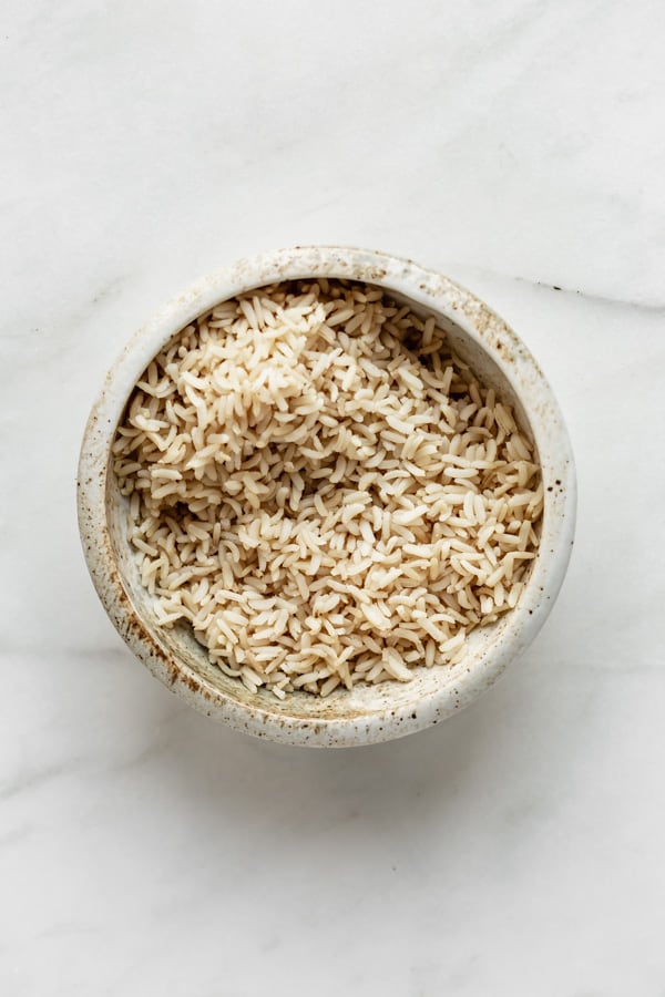 a ceramic bowl with brown rice in it
