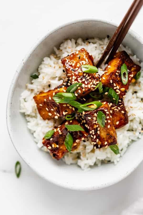 rice and orange tofu in a bowl